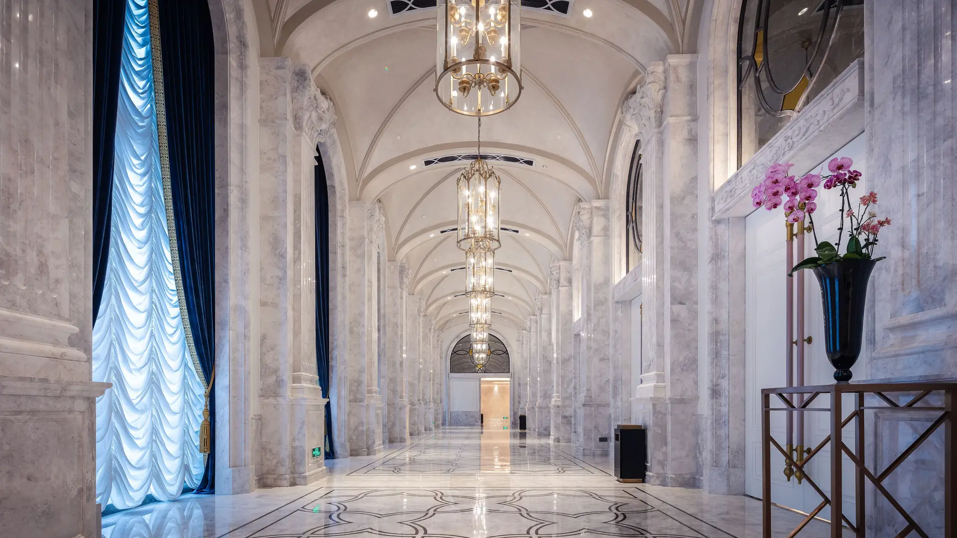 Expansive architectural stone gallery interior with natural daylight