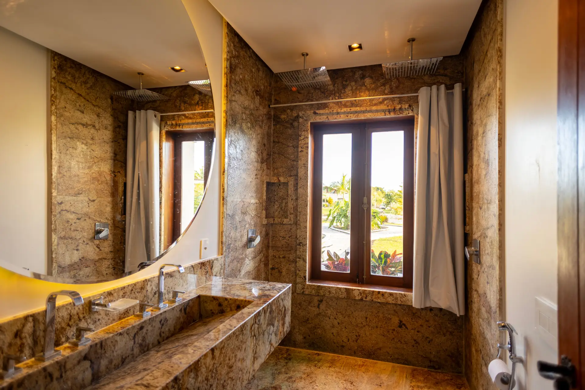 Architectural travertine stone monolithic vanity with brass hardware