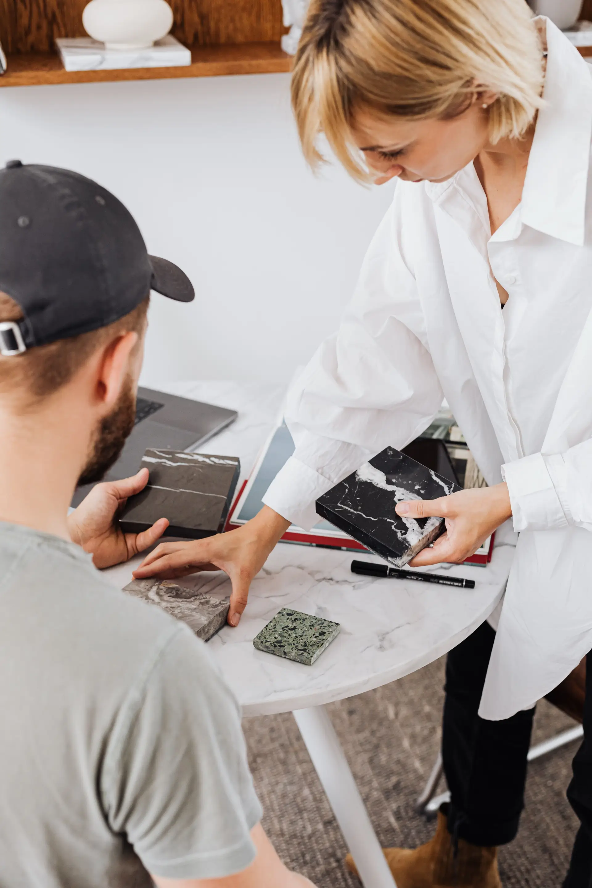 Architectural design consultants inspecting stone and marble slab samples